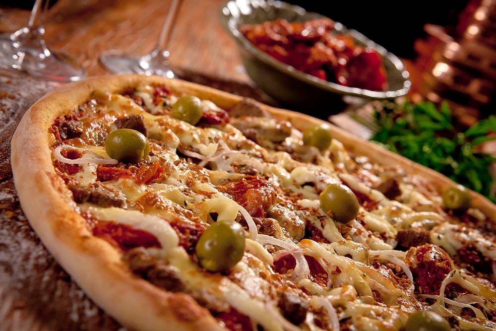 BELLA CAPRI ANTECIPA CAMPANHA DO DIA DA PIZZA E ENTREGA CHEQUES SIMBÓLICOS PARA ENTIDADES ASSISTENCIAIS AMANHÃ 06/07